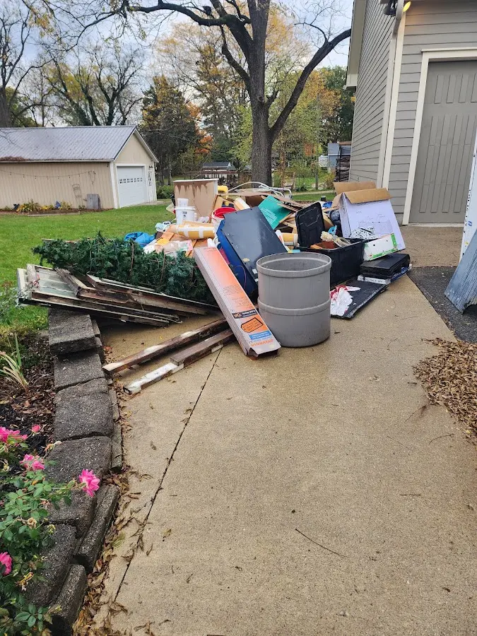 Dumpster being loaded with debris for 12 Yard Dumpster Rental in Knik-Fairview